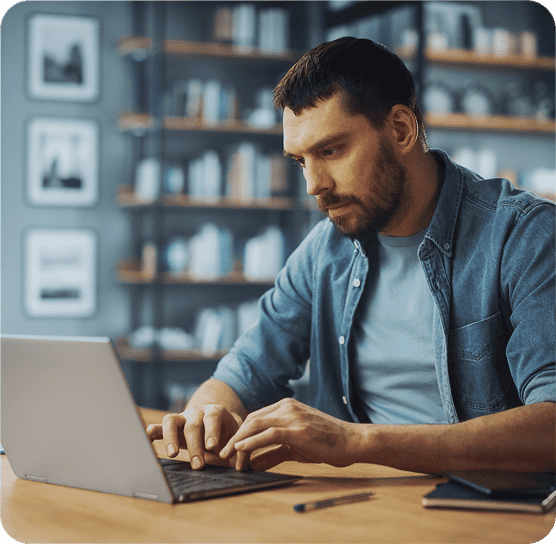 Photo of a business owner looking at software on a laptop