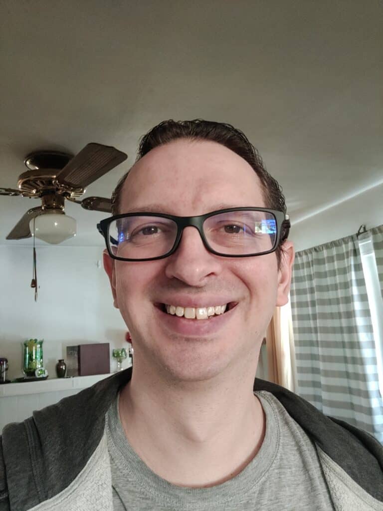 Photo of Bill Wolf smiling in his living room